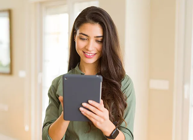 Blog en tu idioma, mujer sonriendo sosteniendo una tablet